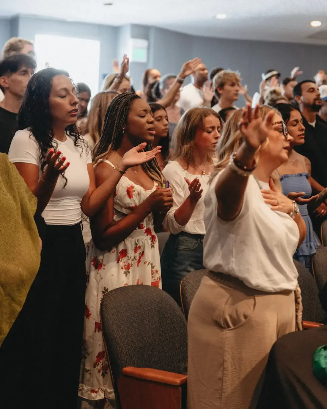 God-Breathed Church congregation worshipping with hands raised during a Sunday service in Orange County, CA